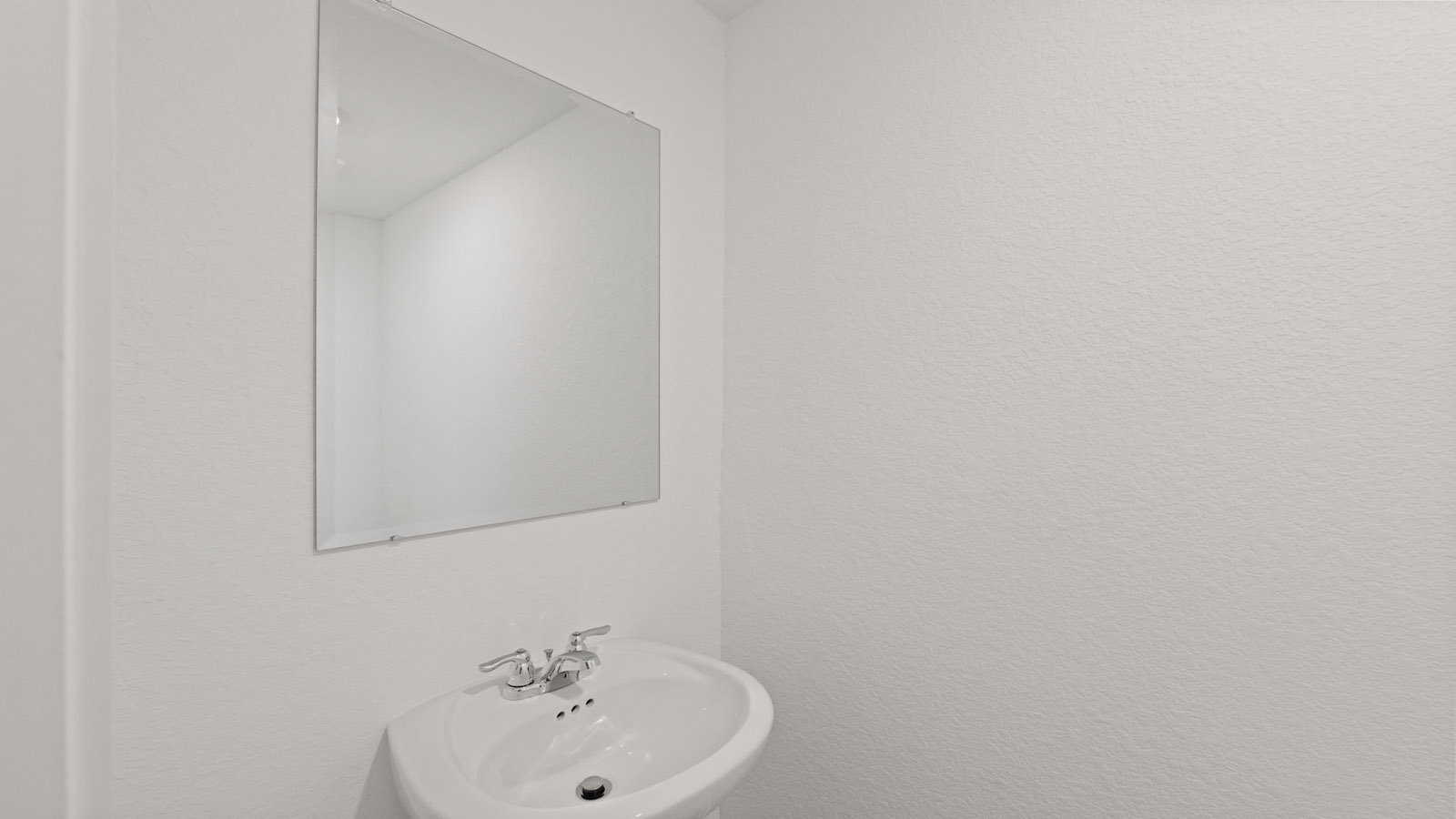 Powder bathroom with pedestal sink right off the foyer entry hallway