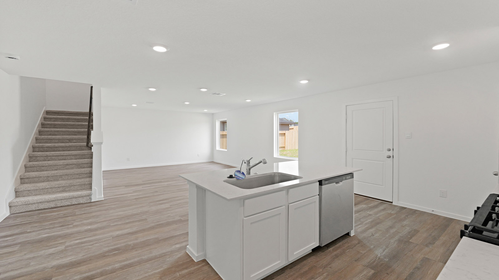 Kitchen with quartz countertops and modern hardware and an island and vinyl floor