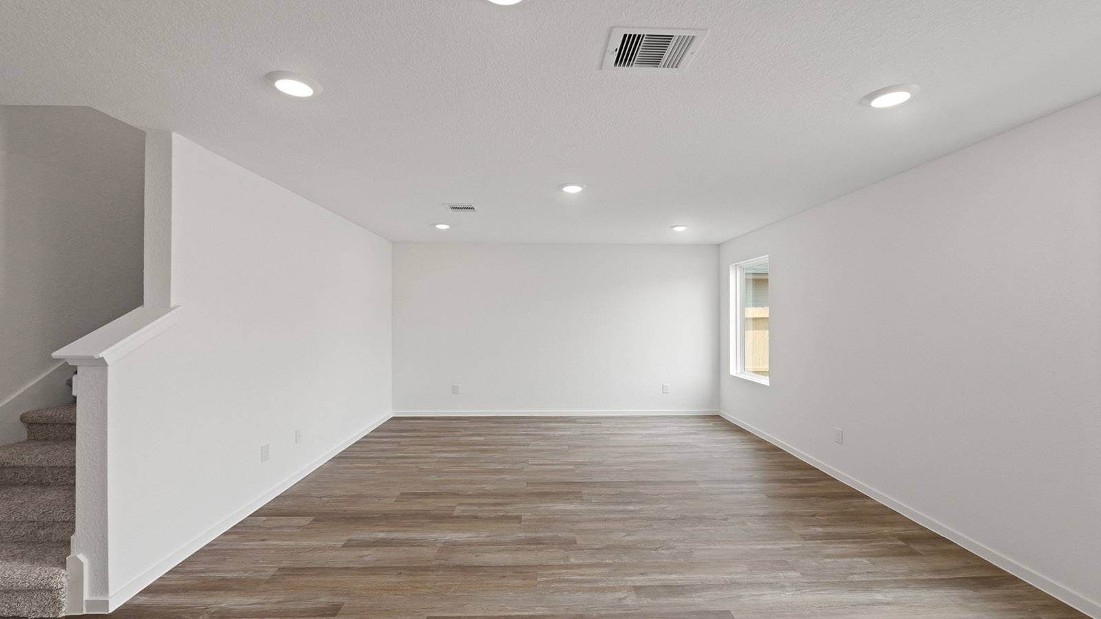 Spacious living area with vinyl flooring and bright windows in Willis TX