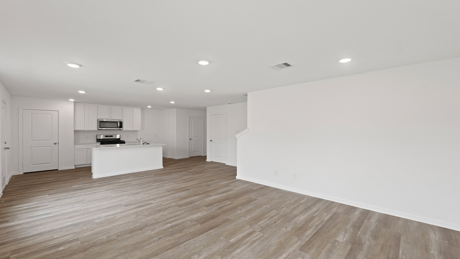 Spacious living area with vinyl flooring and bright windows in Willis TX