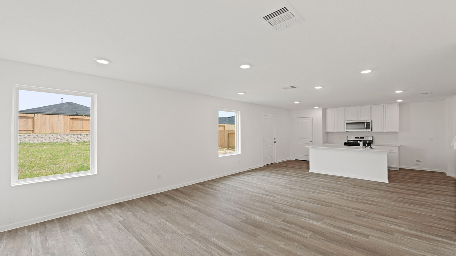 Kitchen with quartz countertops and modern hardware and an island and vinyl floor