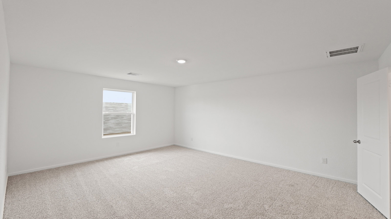 Large Primary bedroom with shag carpet flooring and bright window