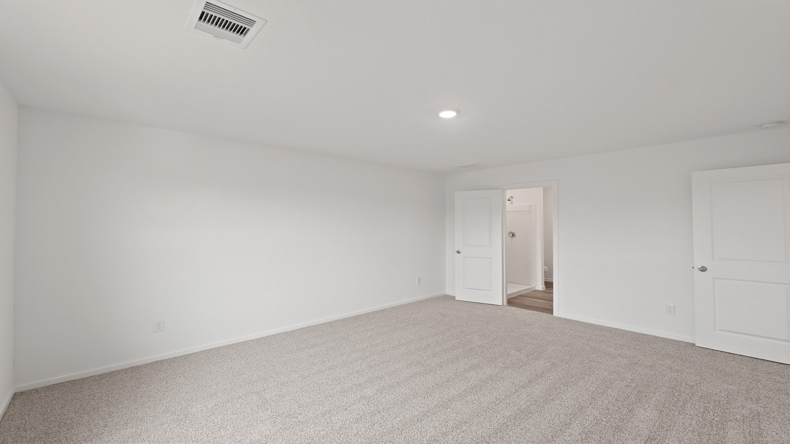 Large Primary bedroom with shag carpet flooring and bright window