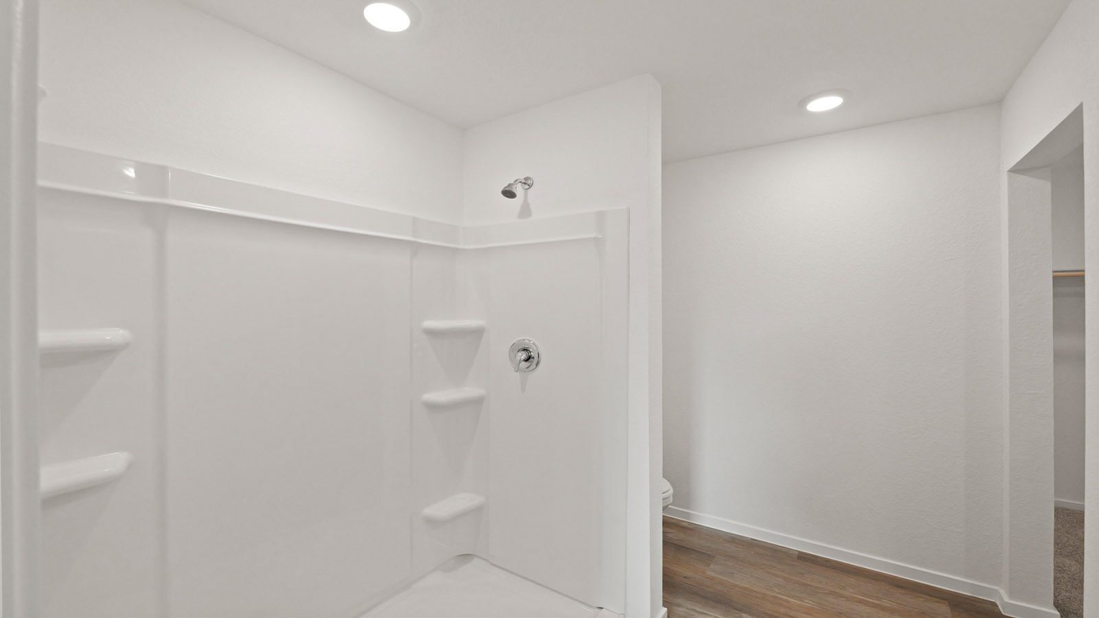 Primary bathroom with stand-alone shower with tiles and semi frameless glass in Willis TX