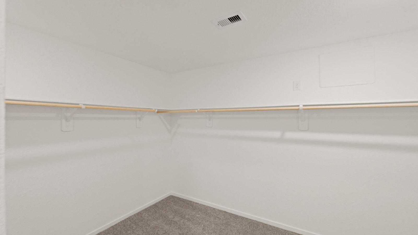 Primary bedroom walk-in closet with carpet flooring in Lake Conroe Cove community in Willis TX