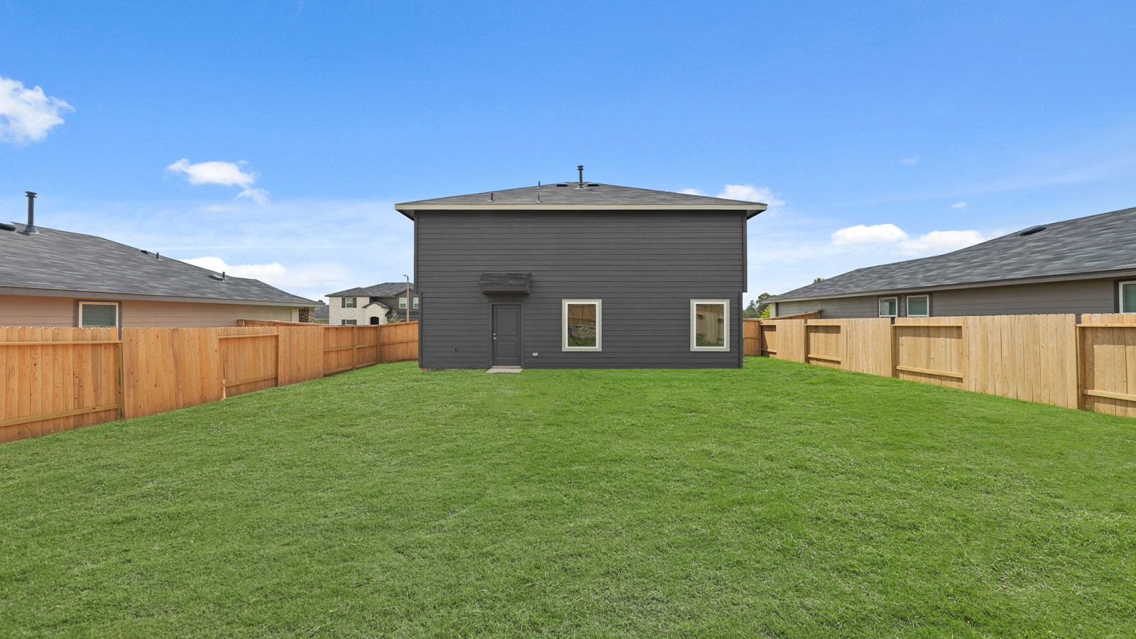 back of house with jamies hardie siding and overhead lighting