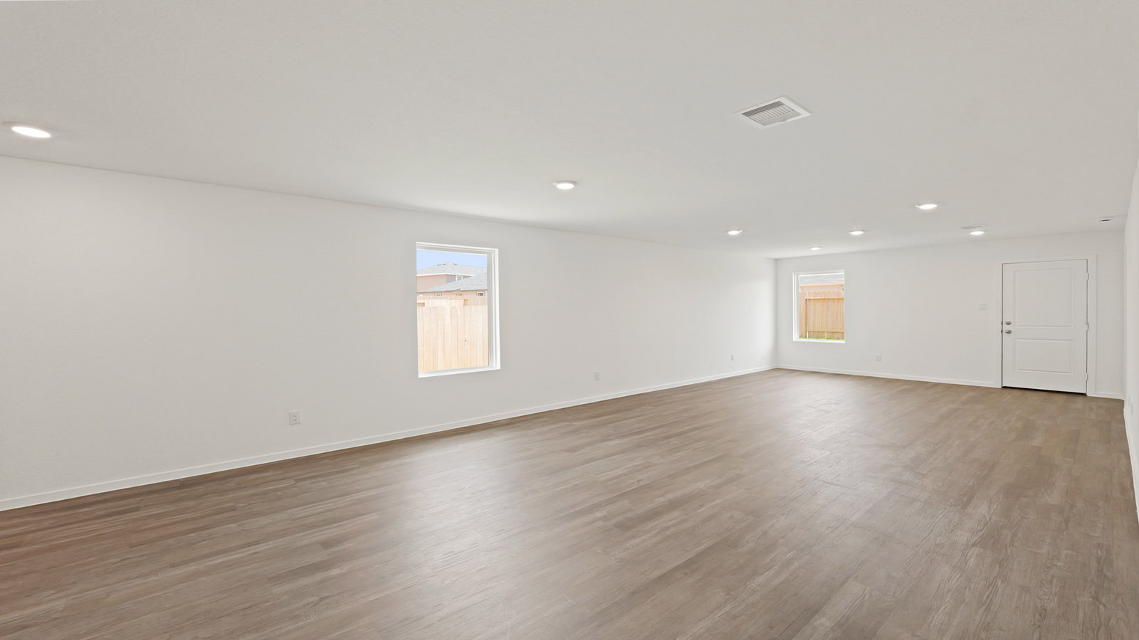 Spacious living area with vinyl flooring and bright windows in Willis TX