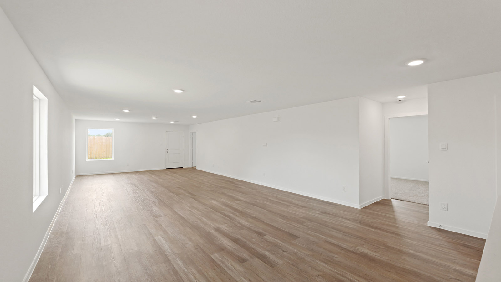 Spacious living area with vinyl flooring and bright windows in Willis TX