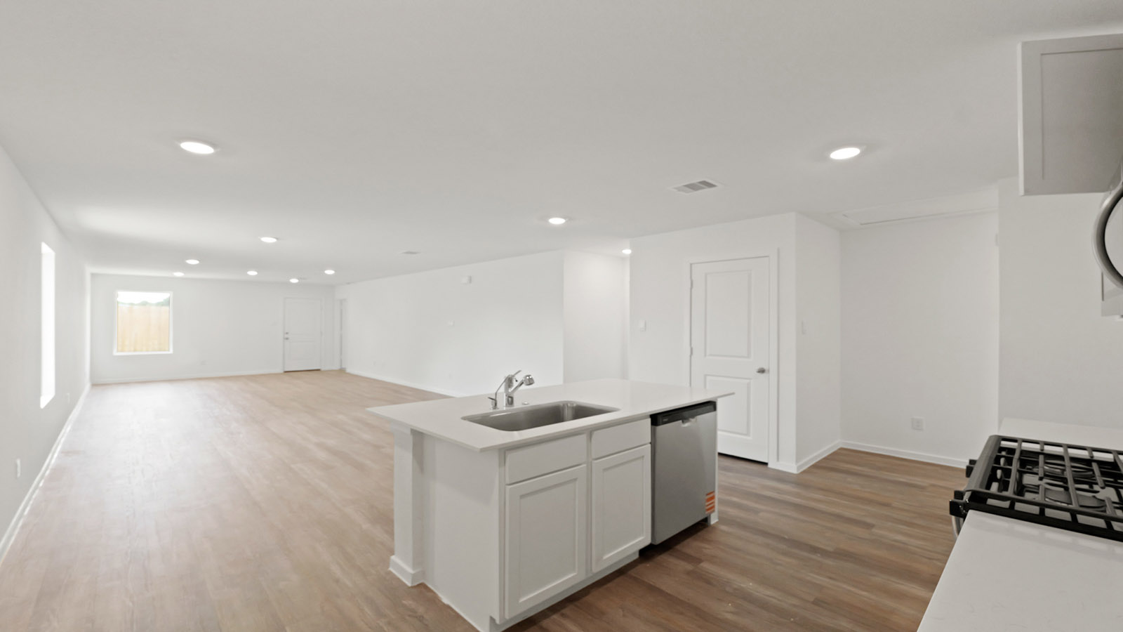 Kitchen with quartz countertops and modern hardware and an island and vinyl floor