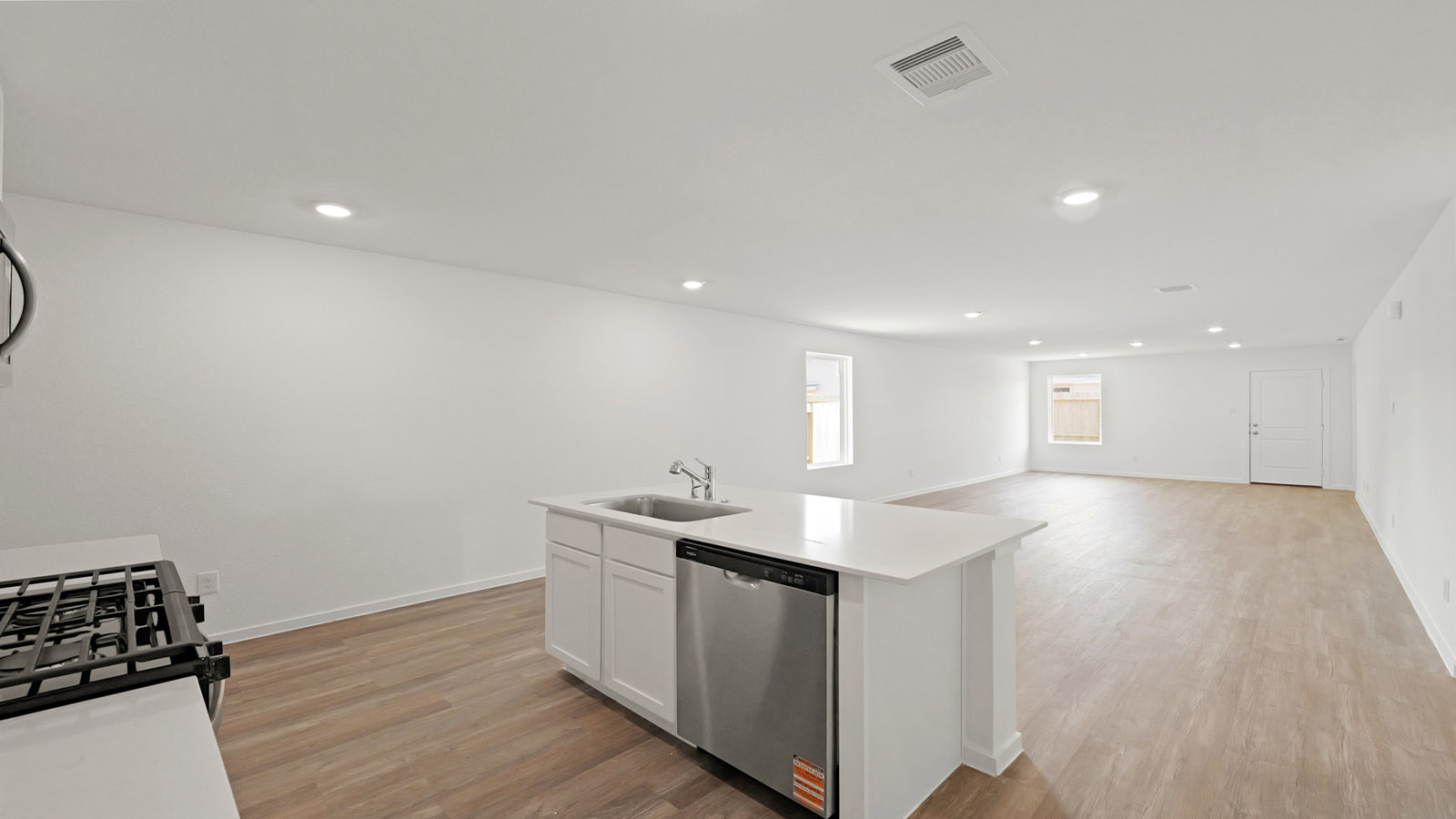 Kitchen with quartz countertops and modern hardware and an island and vinyl floor