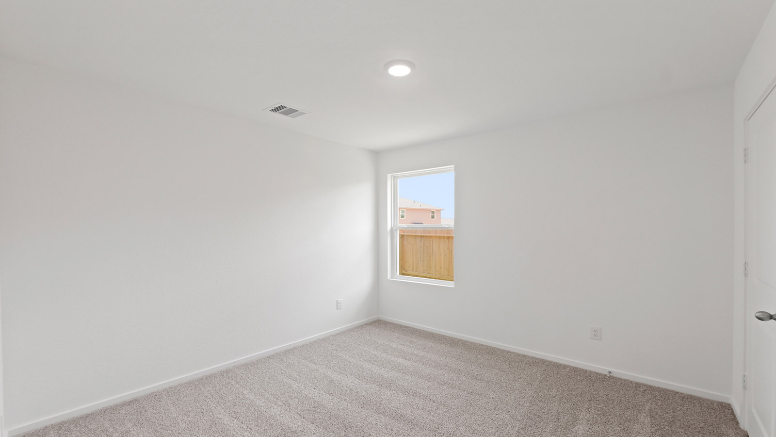 Secondary bedroom with shag carpet flooring and bright window