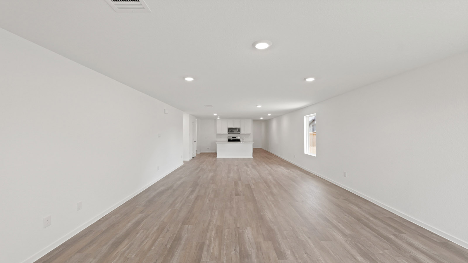 Spacious living area with vinyl flooring and bright windows in Willis TX
