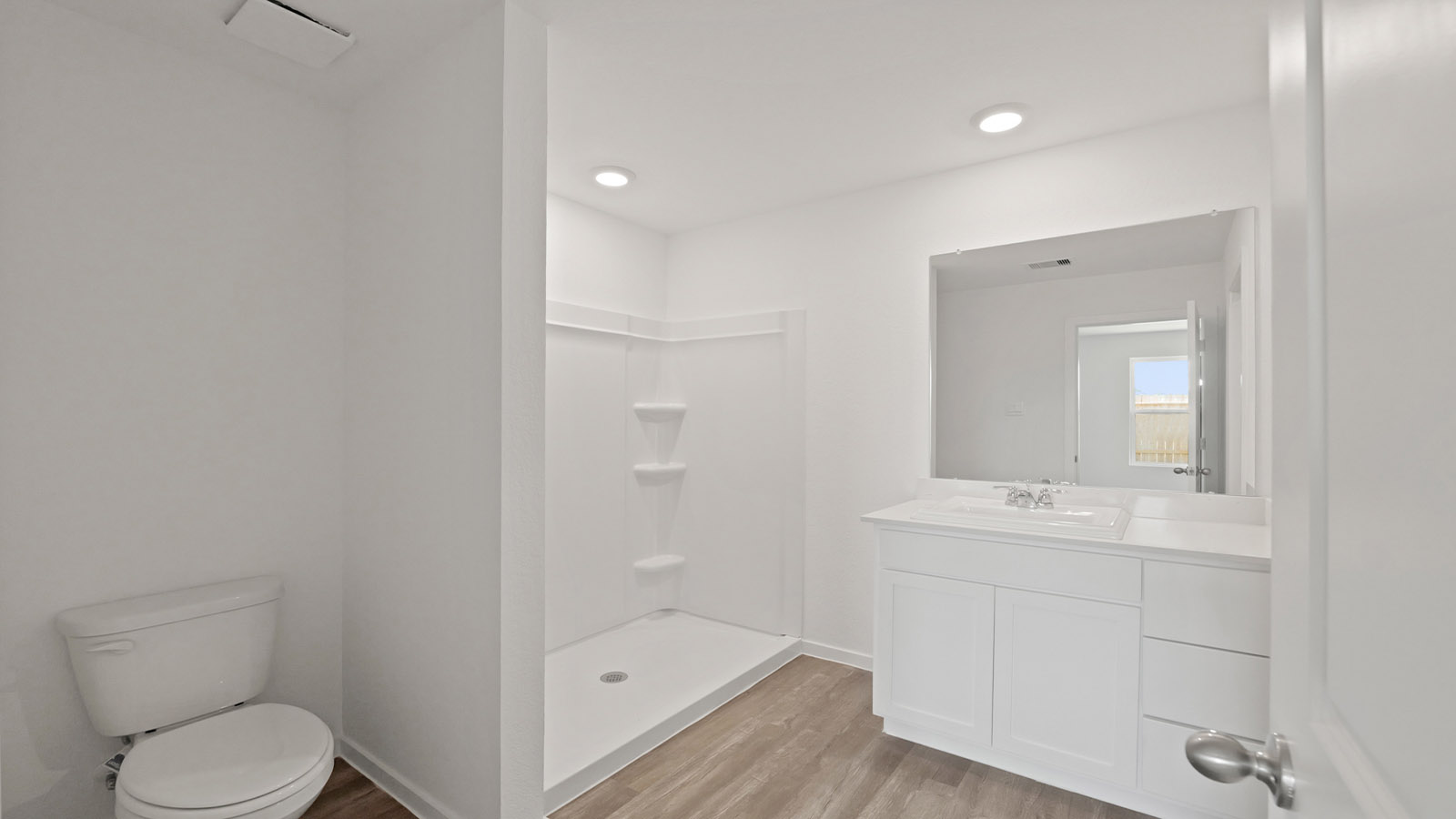 Primary bathroom with stand-alone shower with tiles and semi frameless glass in Willis TX