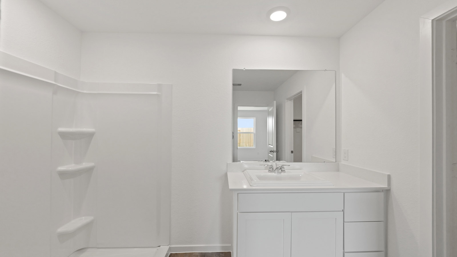 Primary bathroom with stand-alone shower with tiles and semi frameless glass in Willis TX
