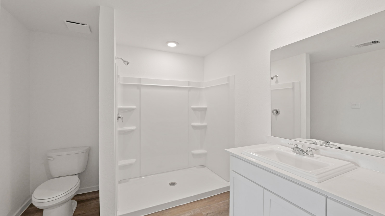 Primary bathroom with stand-alone shower with tiles and semi frameless glass in Willis TX