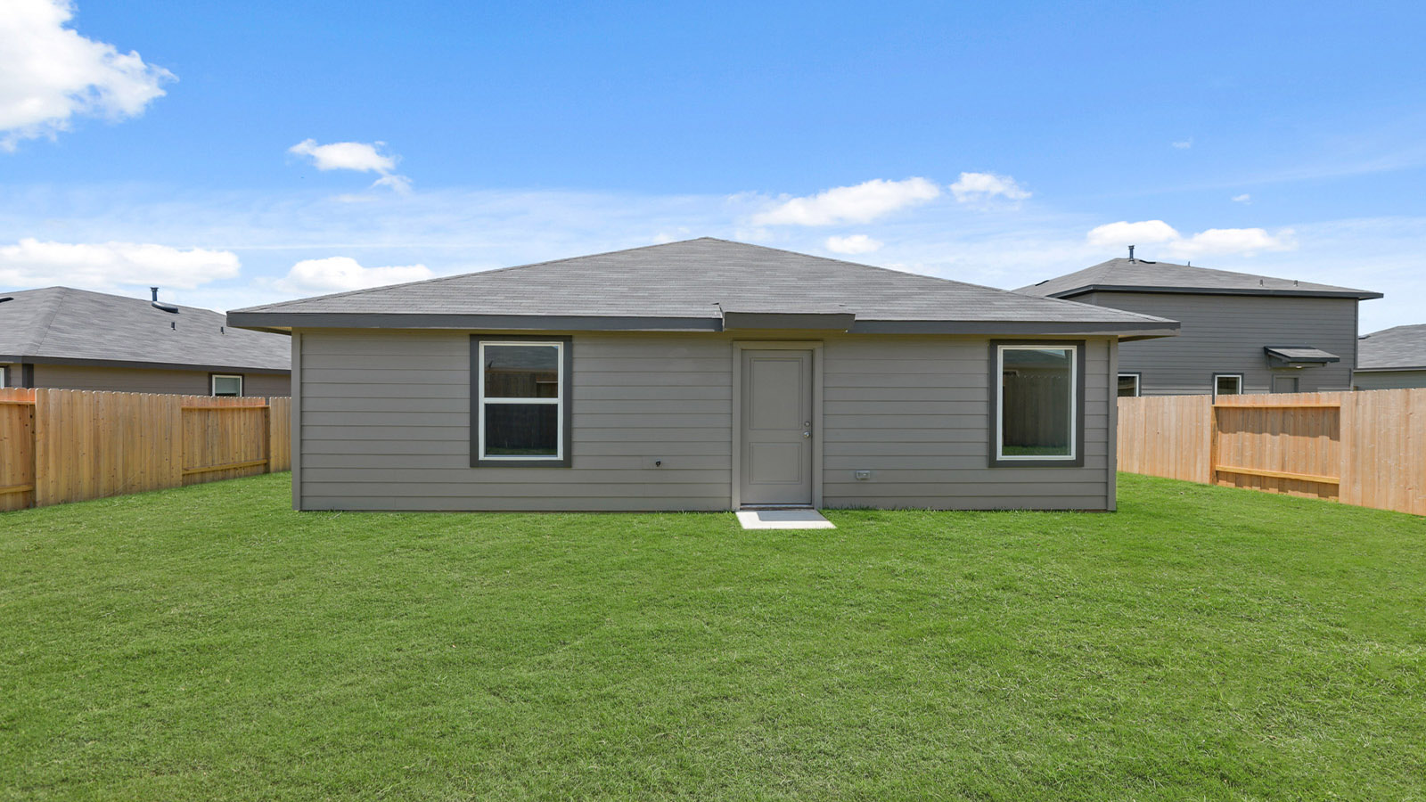 back of house with jamies hardie siding and overhead lighting