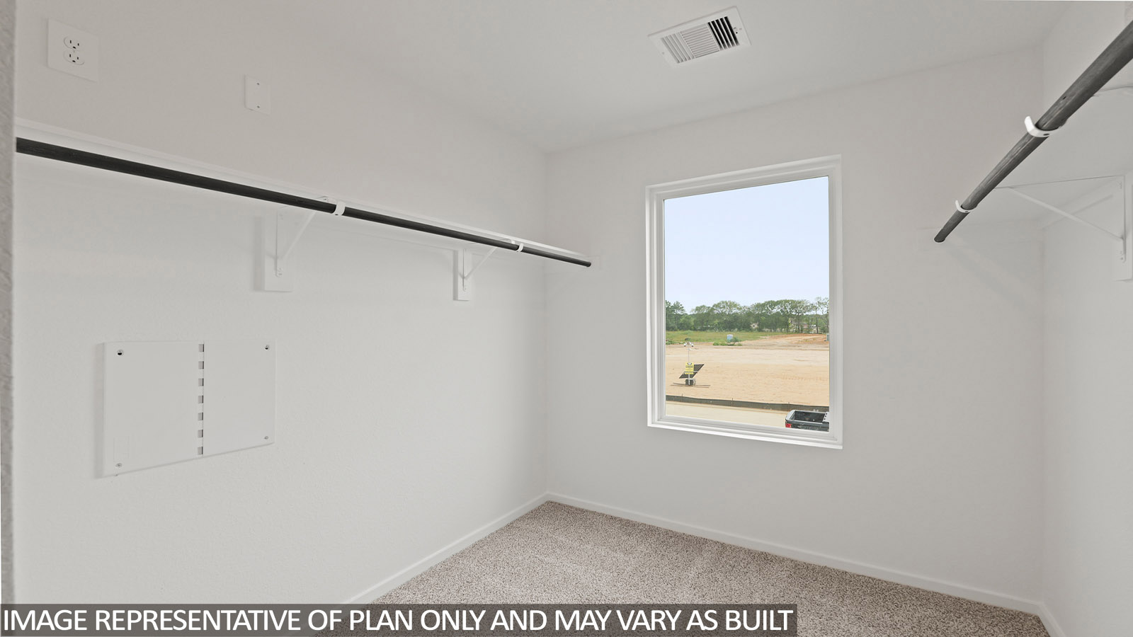 Primary bedroom walk-in closet with carpet flooring in Lake Conroe Cove community in Willis TX