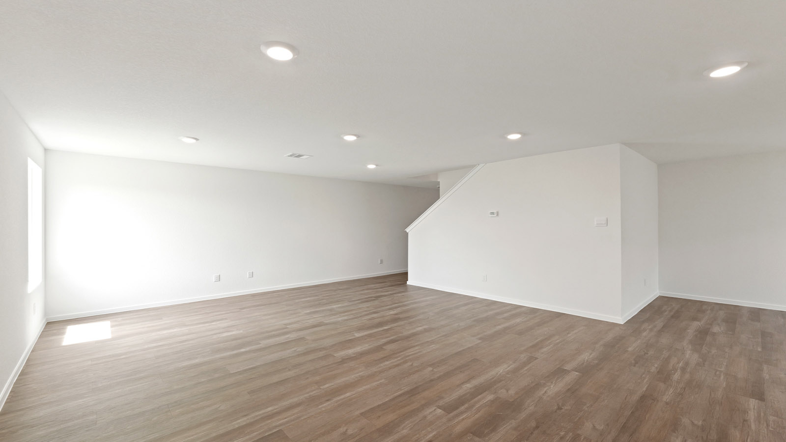 Spacious living area with vinyl flooring and bright windows in Willis TX