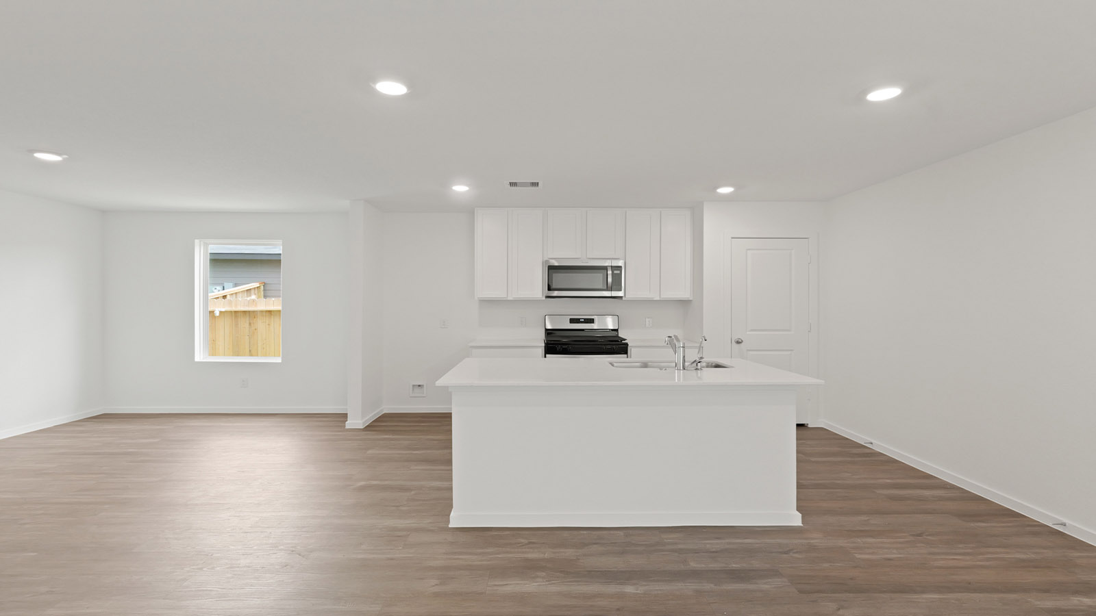Kitchen with quartz countertops and modern hardware and an island and vinyl floor
