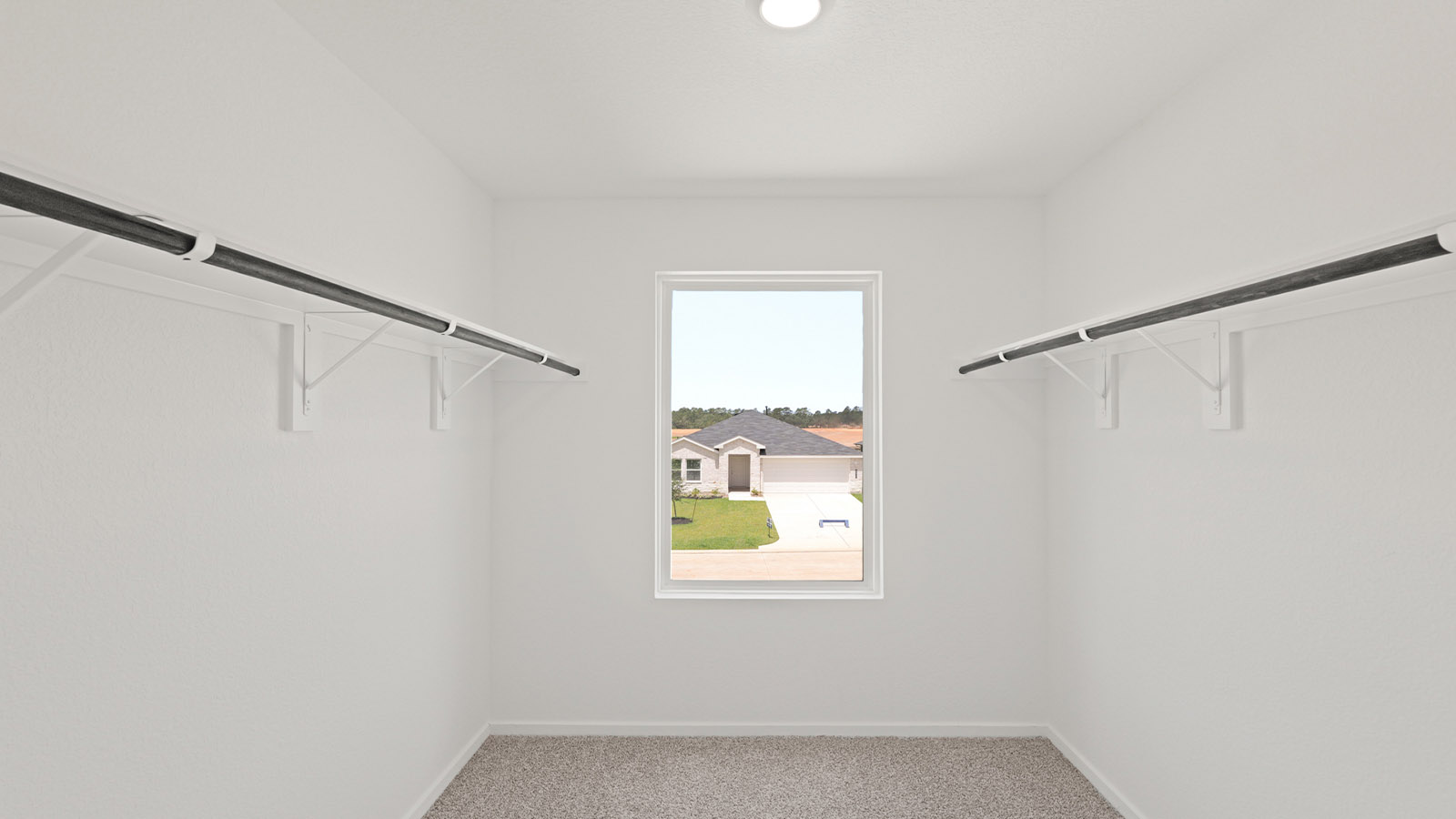 Primary bedroom walk-in closet with carpet flooring in Lake Conroe Cove community in Willis TX
