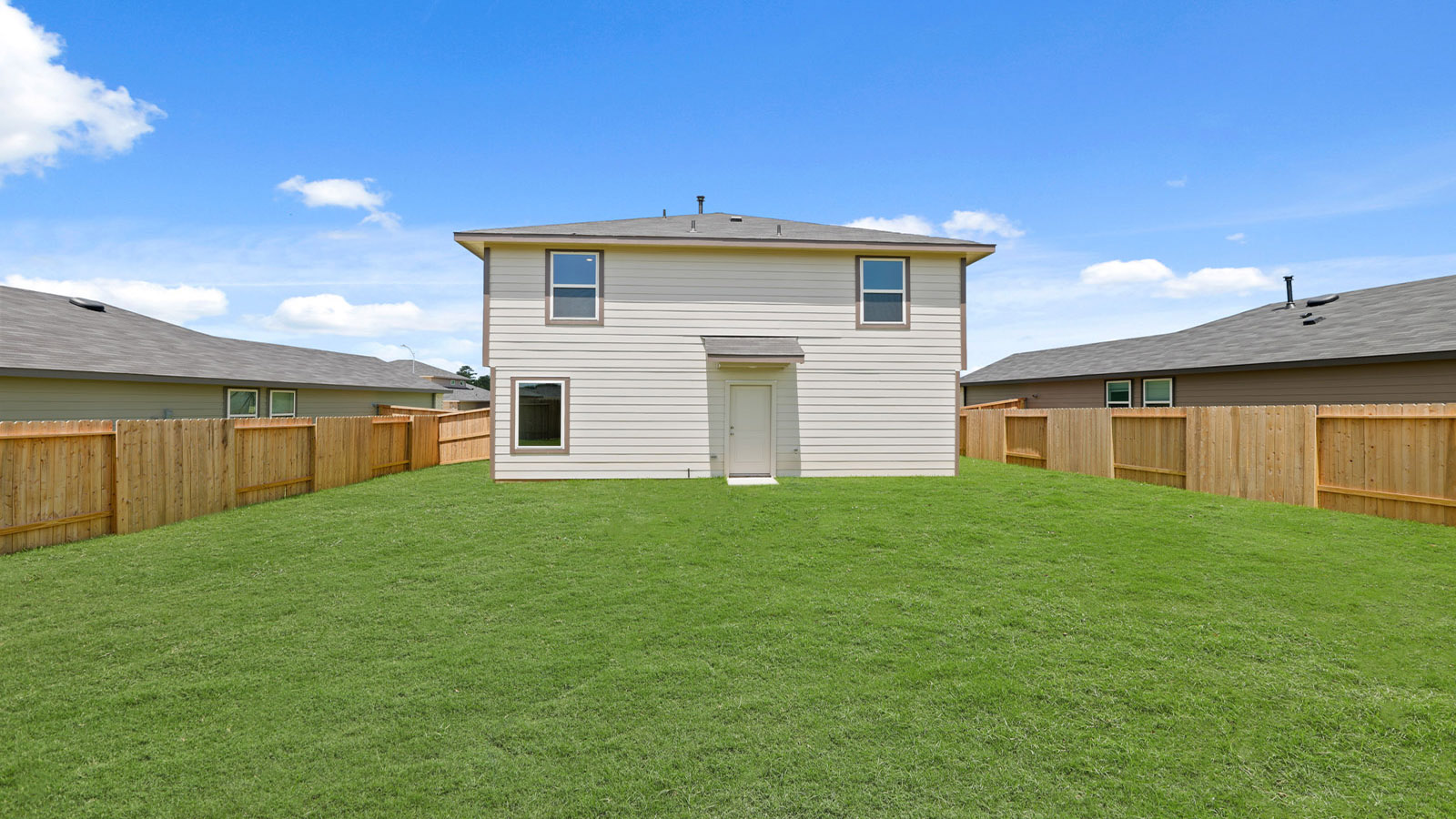 back of house with jamies hardie siding and overhead lighting