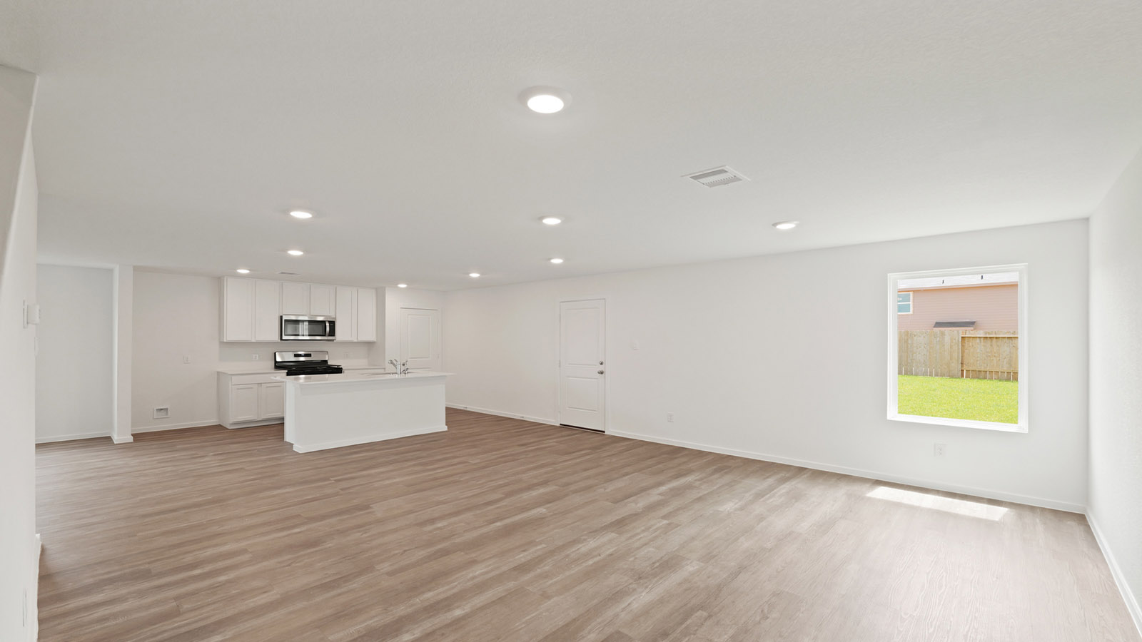 Spacious living area with vinyl flooring and bright windows in Willis TX