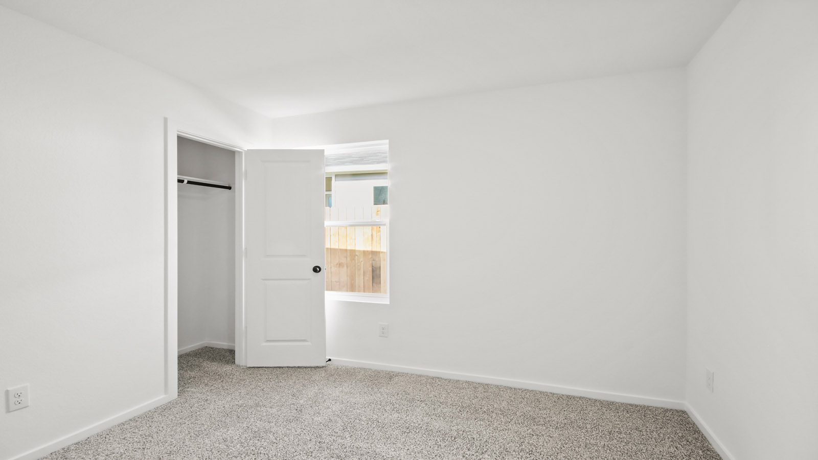 Secondary bedroom with carpet flooring