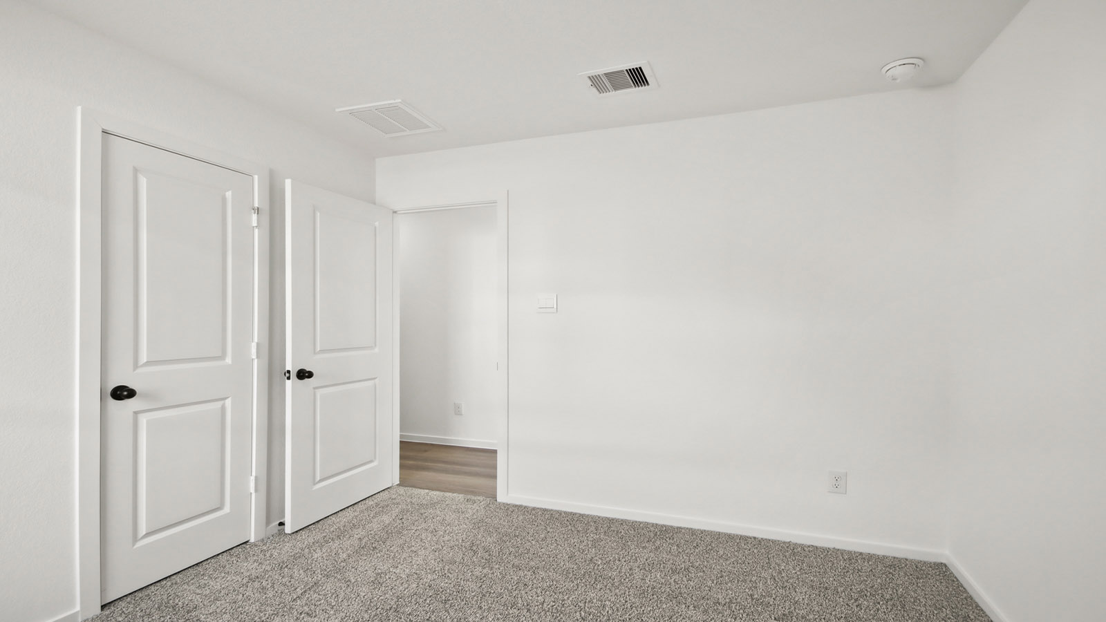 Secondary bedroom with carpet flooring