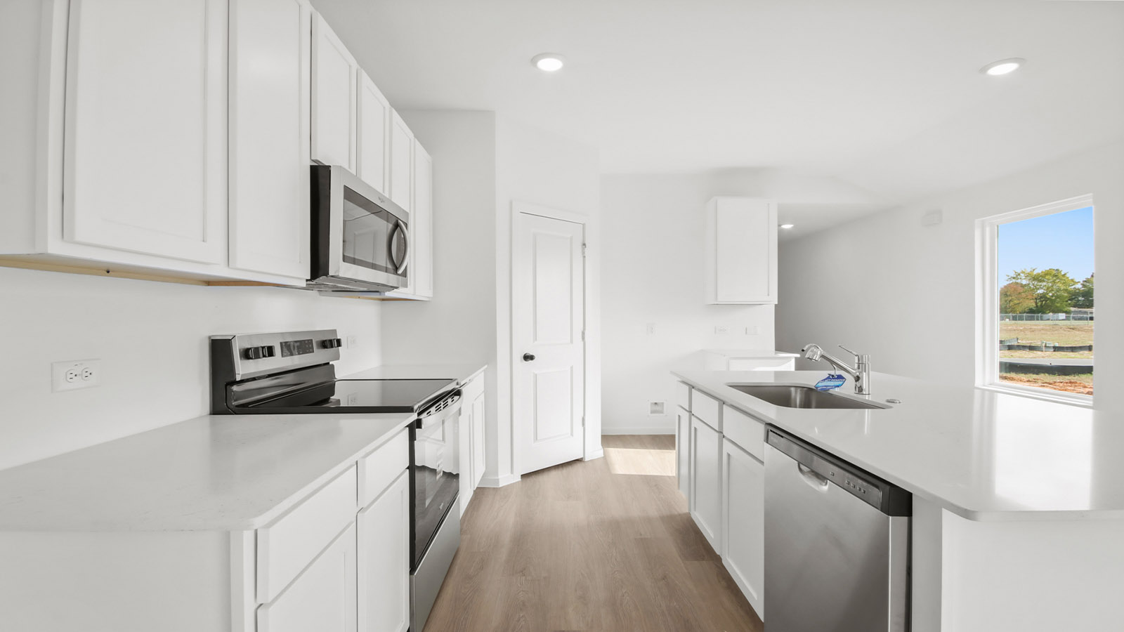 Kitchen with quartz countertops and modern hardware and an island and vinyl floor