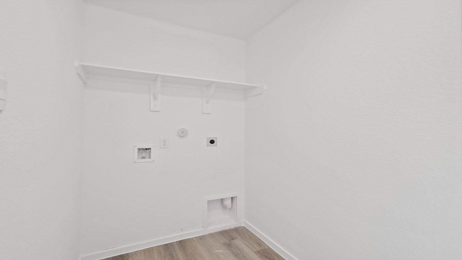 Utility room with storage located off the entry hallway and garage door