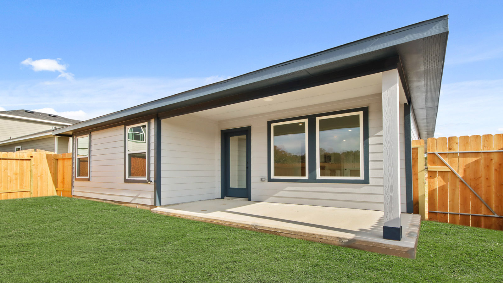 covered patio with jamies hardie siding and overhead lighting