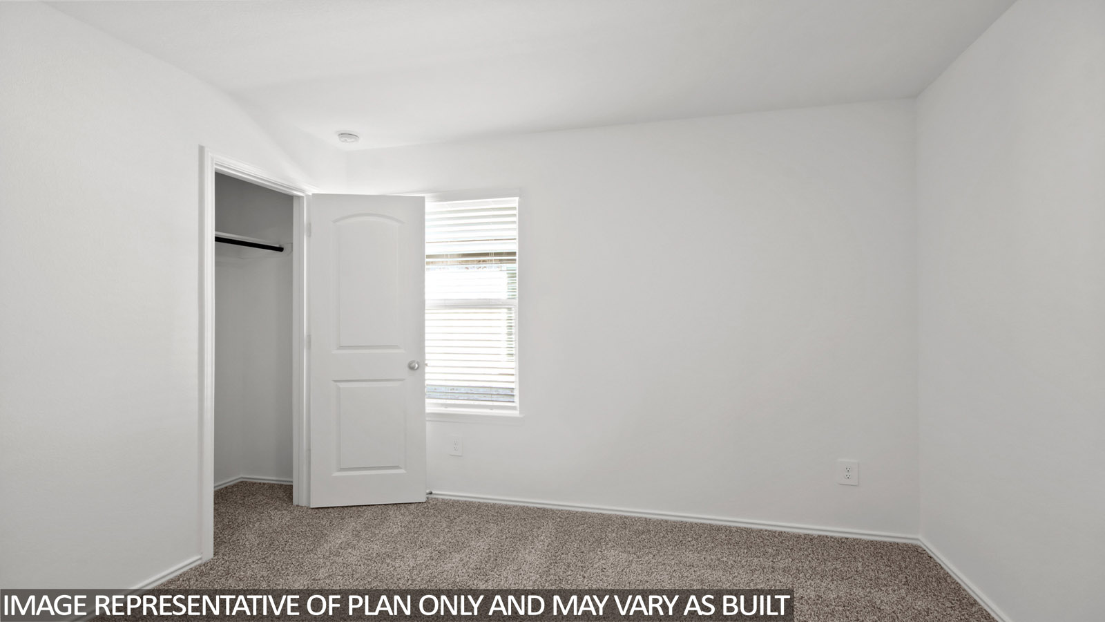 Secondary bedroom with windows, white walls, and light carpet.