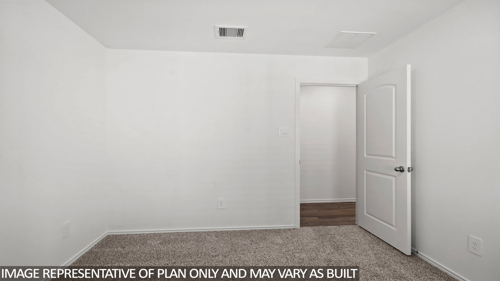 Secondary bedroom with windows, white walls, and light carpet.