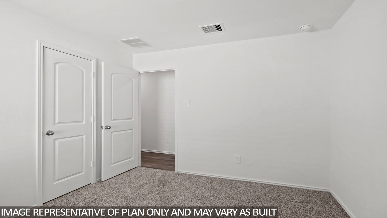 Secondary bedroom with windows, white walls, and light carpet.