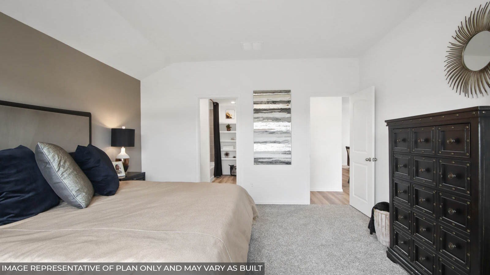 Primary bedroom with windows, white walls, and light carpet.