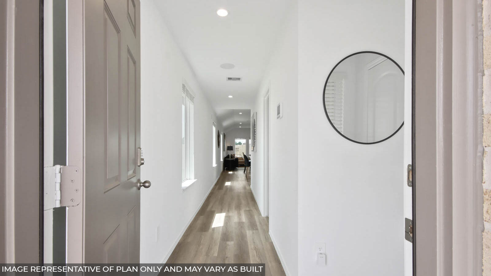 Entry hallway with white walls and vinyl wood flooring.