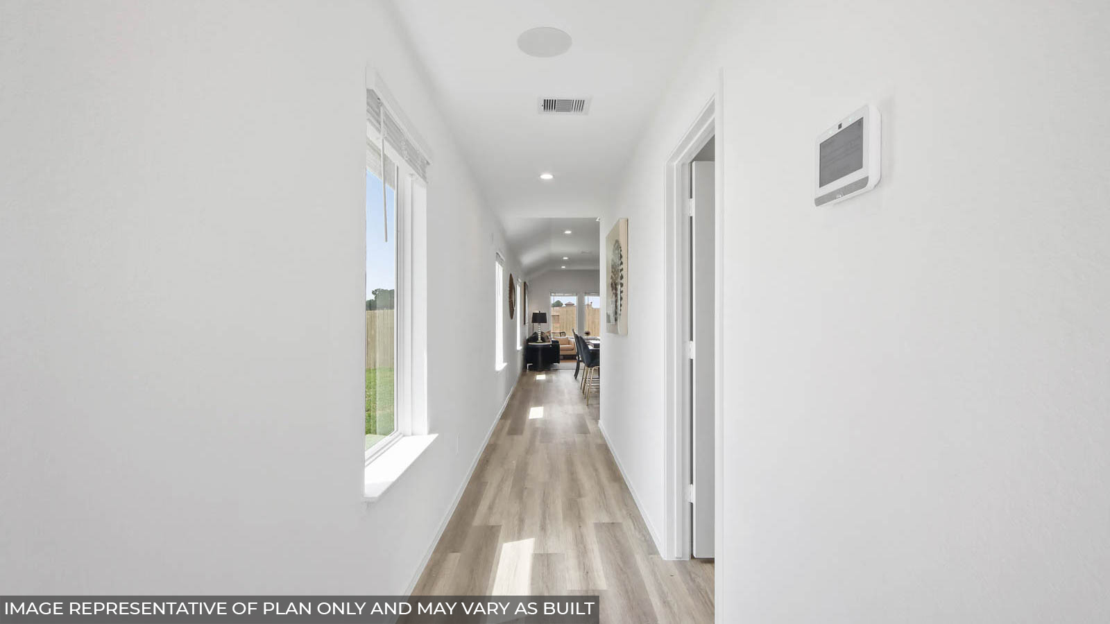 Entry hallway with white walls and vinyl wood flooring.