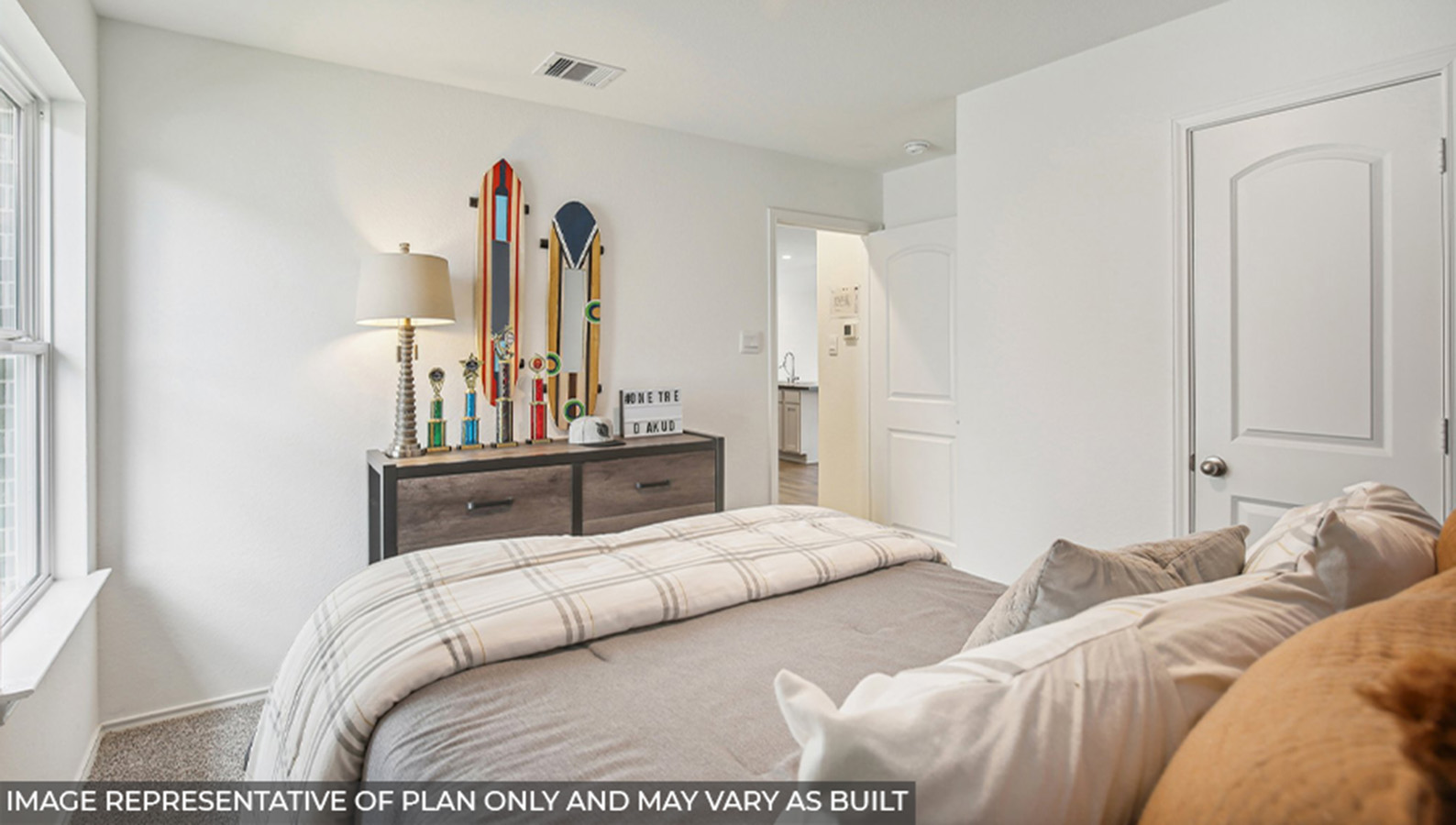 Secondary bedroom with windows, white walls, and light carpet.