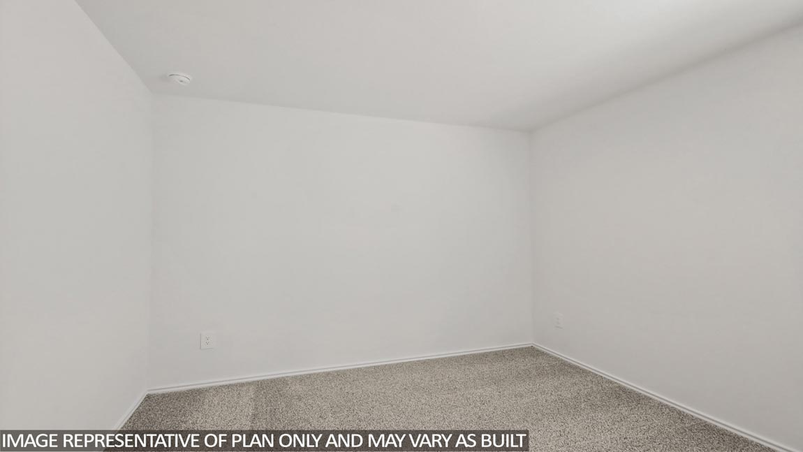 Secondary bedroom with carpet flooring