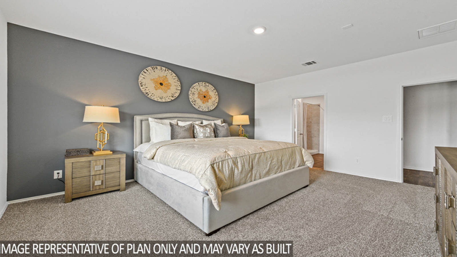 Primary bedroom with windows, white walls, and light carpet.