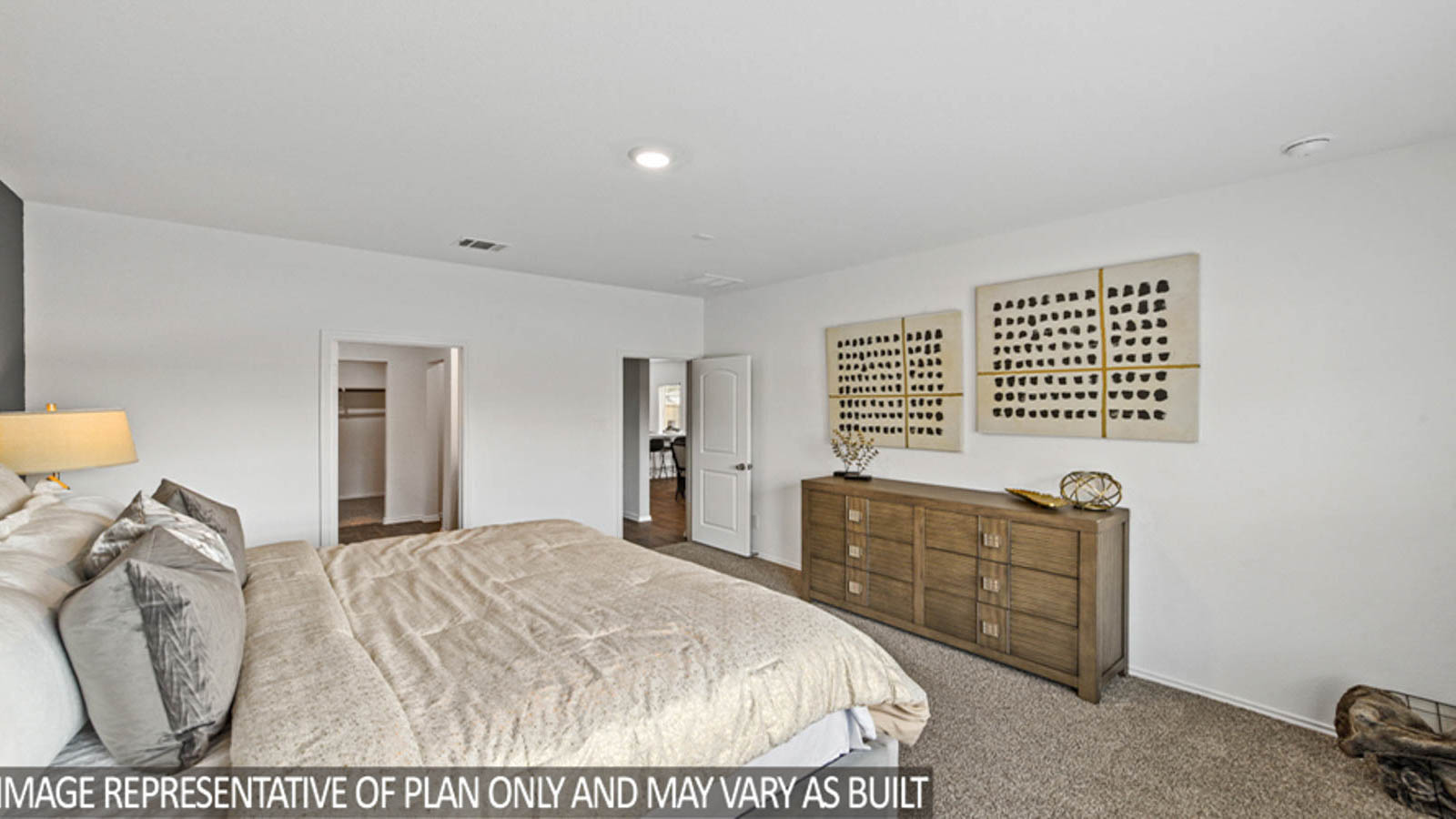 Primary bedroom with windows, white walls, and light carpet.