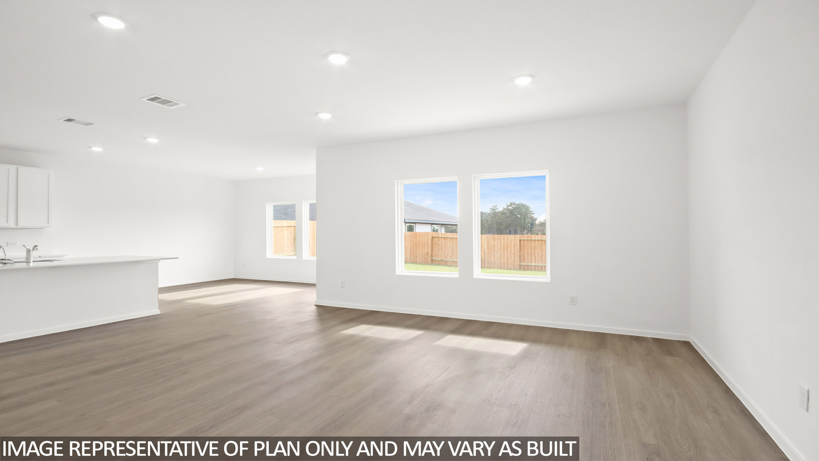 Spacious living area with vinyl flooring