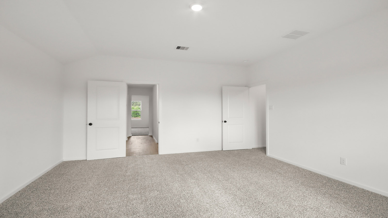 Primary bedroom with carpet flooring
