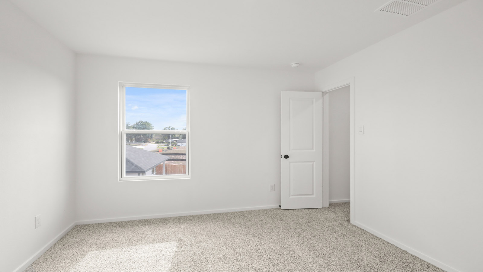 Secondary bedroom with carpet flooring
