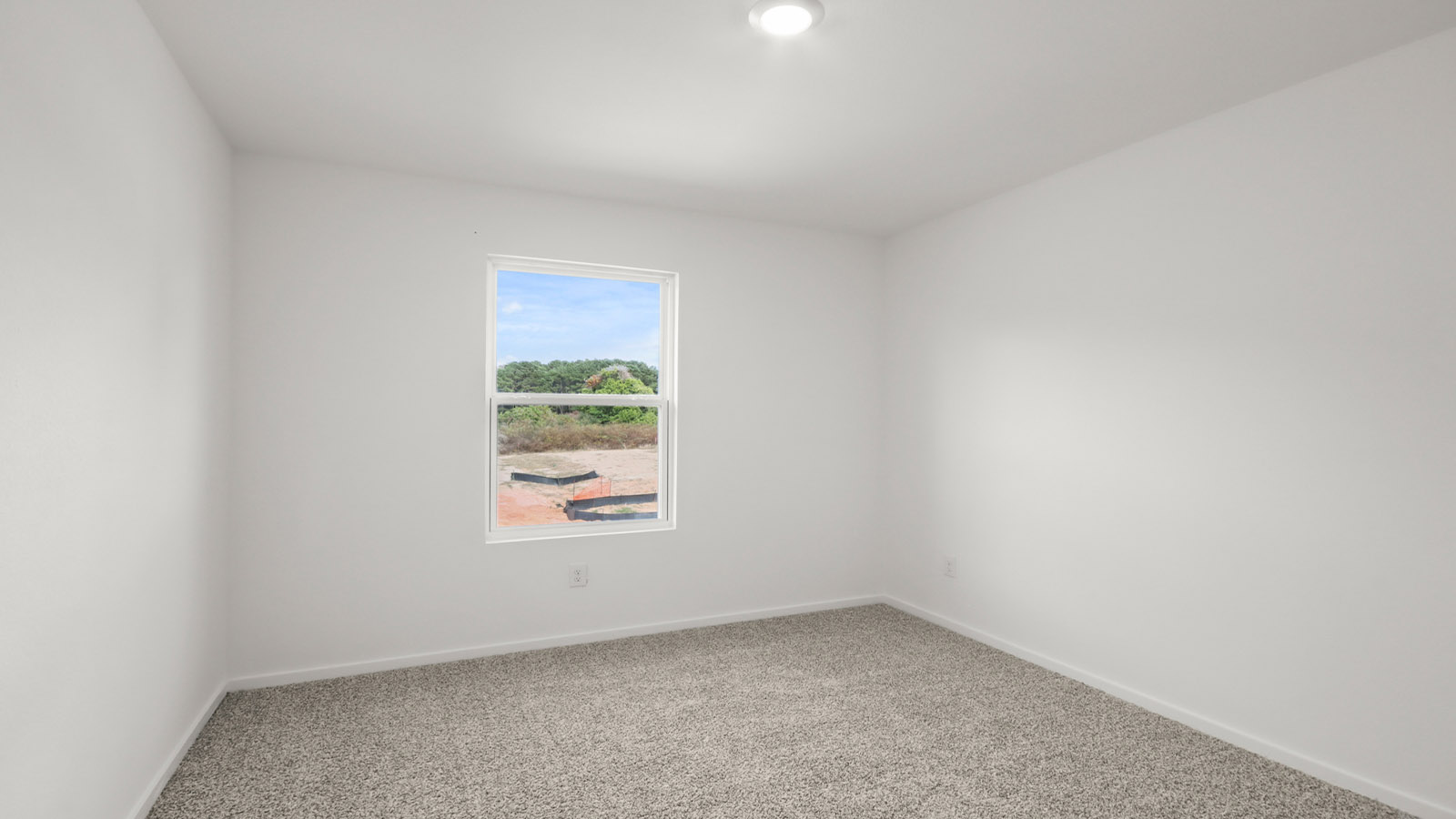 Secondary bedroom with carpet flooring