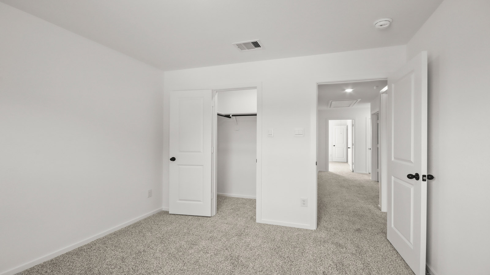 Secondary bedroom with carpet flooring