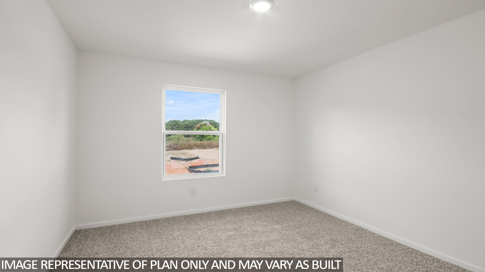 Secondary bedroom with carpet flooring