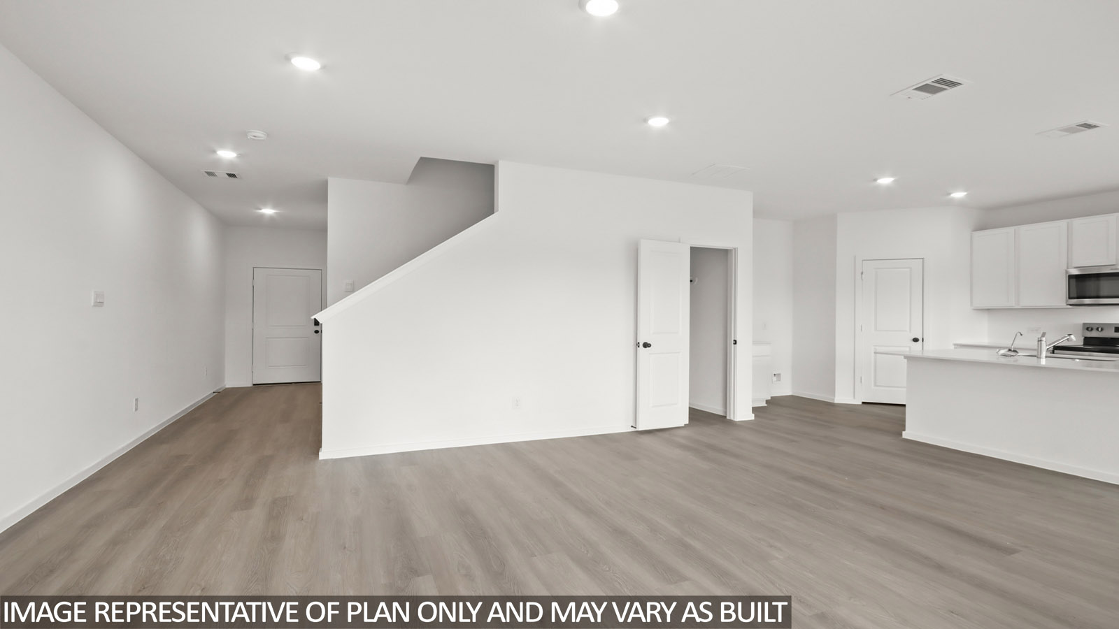 Spacious living area with vinyl flooring