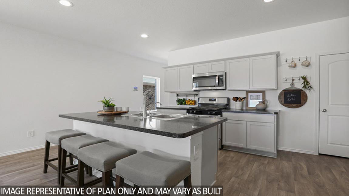 Open kitchen with an island, stainless steel appliances, white cabients, white walls, and vinyl wood flooring.
