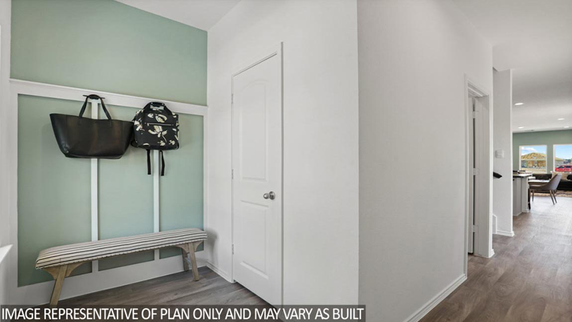 Entry hallway with white walls and vinyl wood flooring.